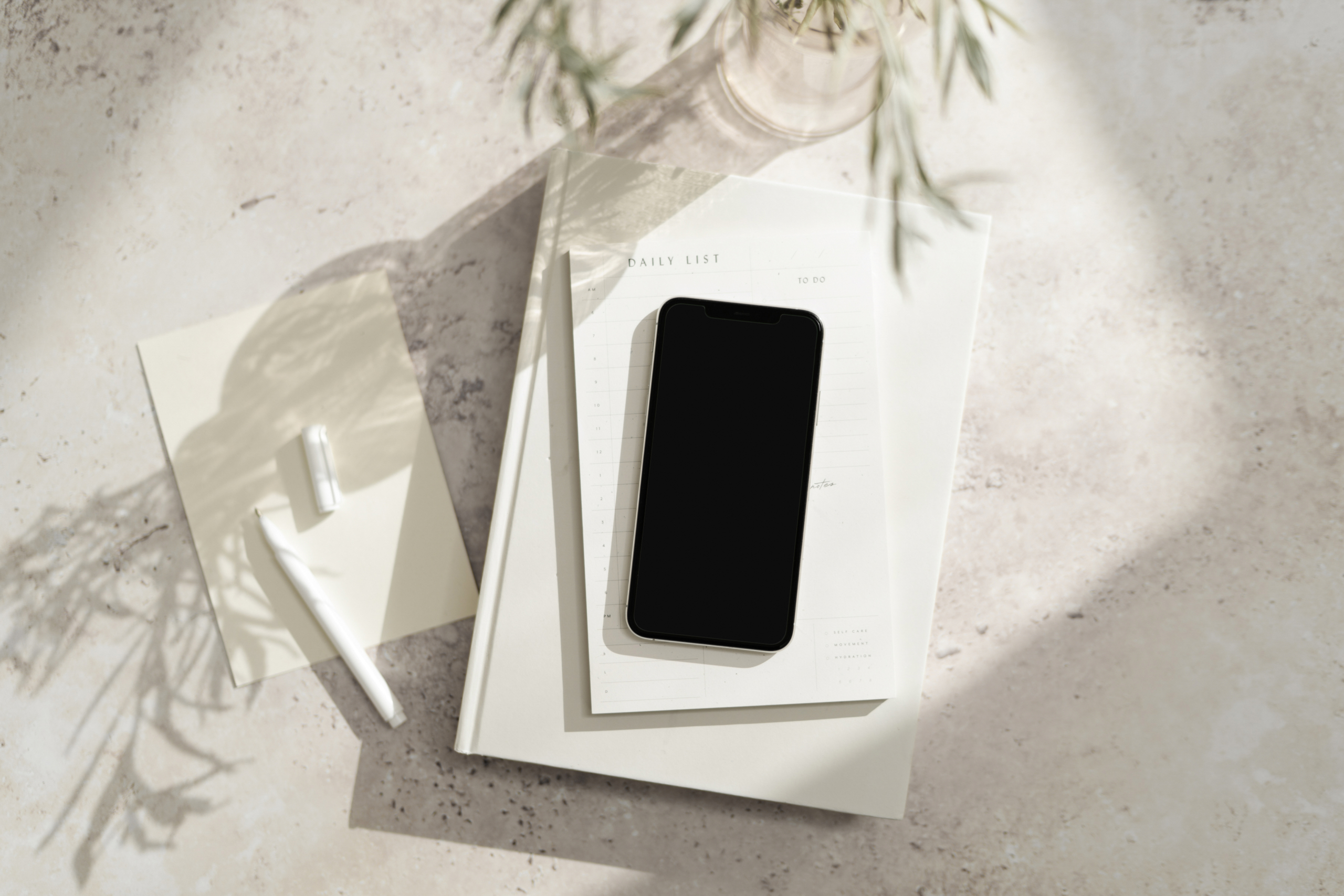 phone on white pad of paper